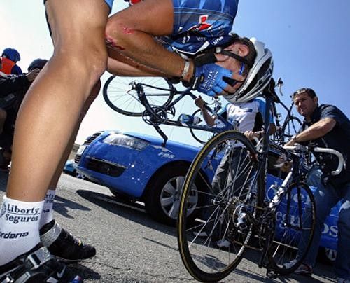 Dariusz Baranowski (Liberty Seguros) clutches his face after coming down in a fall early in the race.