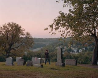 Photographer shooting gravestone