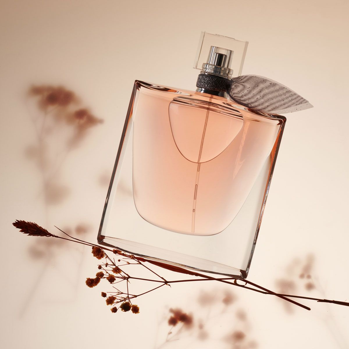 Lancôme La Vie Est Belle Eau de Parfum floral perfume shot on a flower stem