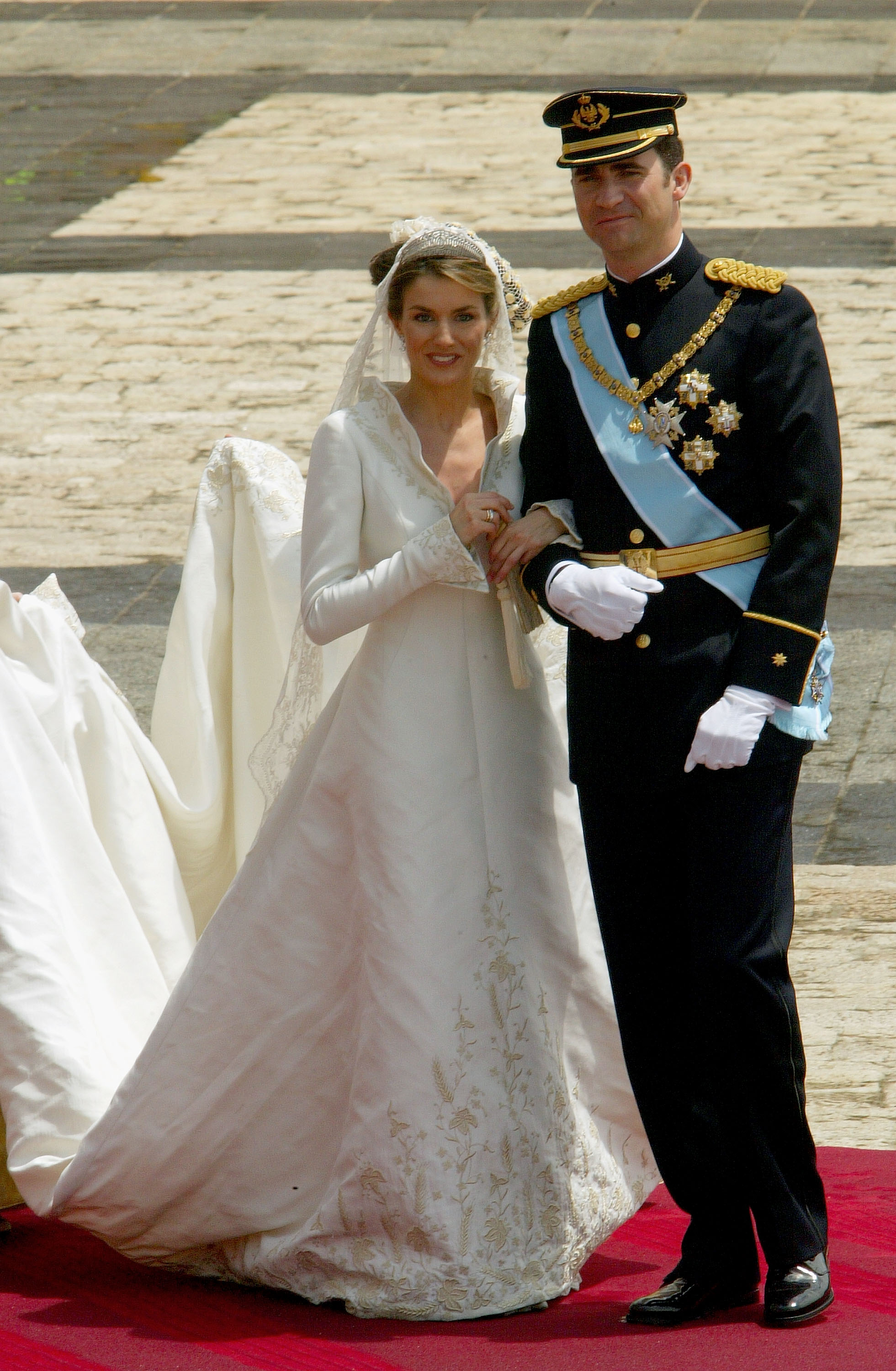Queen Letizia on her wedding day standing outside the church with King Felipe