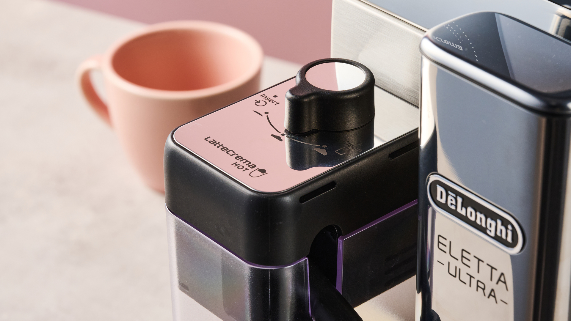 A closeup of the top of the De'Longhi Eletta Ultra's hot milk carafe, showing its three different foam settings.