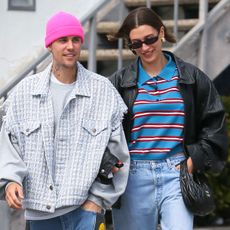 hailey bieber wearing a striped polo shirt and justin bieber wearing a plaid jacket