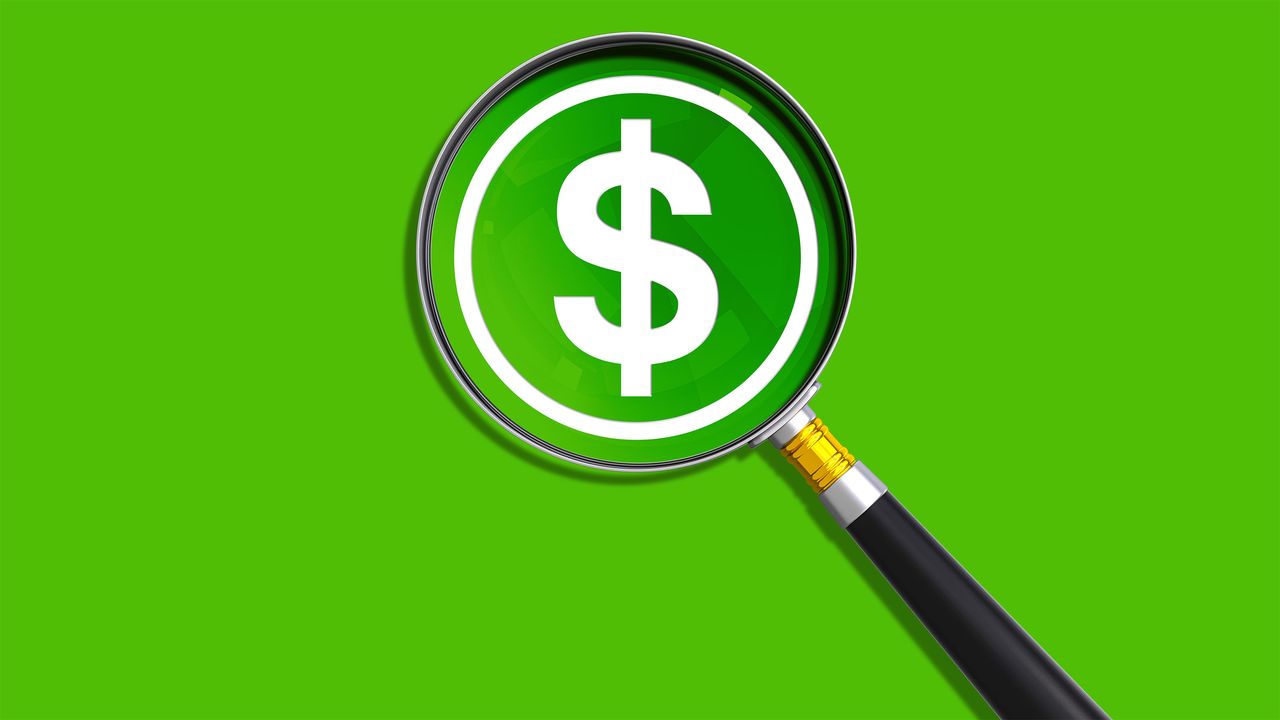 Magnifying glass with dollar sign and a green background