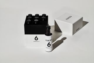 Open box of Jukes 6 cordiality showing nine miniature bottles