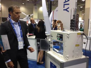David Avino, managing director of Italian engineering and software firm Argotec, demonstrates the ISSpresso machine at the International Astronautical Congress in Toronto on Sept. 29, 2014.