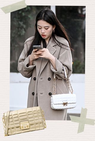 One of the best Michael Kors bags is shown in a photo of a woman wearing a tan coat over a black dress with a white quilted fold-over flap shoulder bag with a chain strap