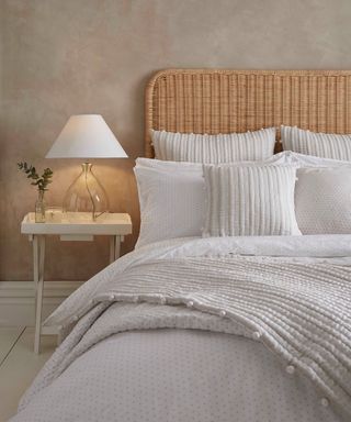 neutral bedroom with white bedding and nightstand