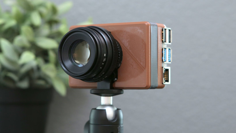 A Raspberry Pi camera case on a tripod