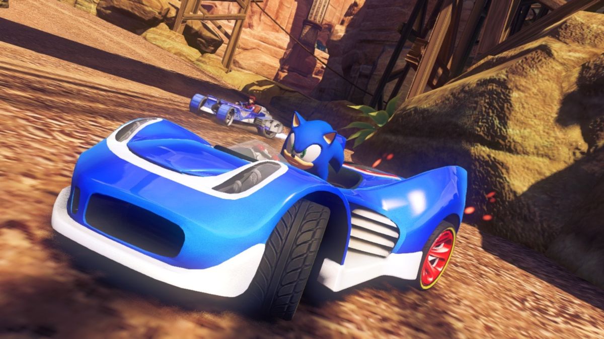 On a dirt racetrack in Sonic &amp;amp; All-Stars Racing Transformed, Sonic speeds in a blue sports car