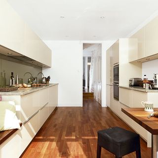 Kitchen with white wall and wooden flooring