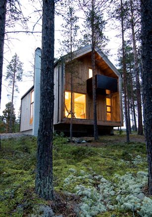 The Zerhouse Project by Huus Og Heim Architects, Norway. A double storey wood cabin in a forest surrounded by trees.