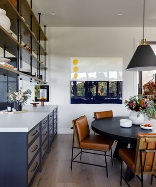 Industrial style kitchen with wooden beams and wooden cabinets with steel countertops