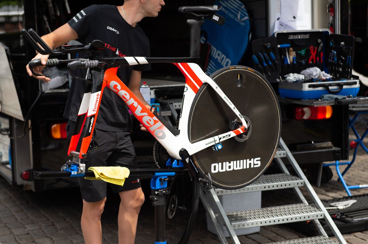 A Sunweb mechanic works on a team bike ahead of the stage