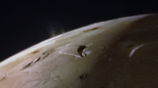A view of the top of Io, a slight haze protrudes from the surface in one isolated location.