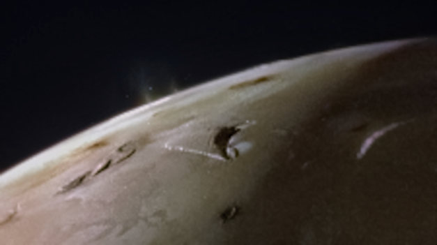 A view of the top of Io, a slight haze protrudes from the surface in one isolated location.