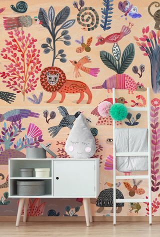 A bright colorful animal design playroom mural with white ladder and console table.