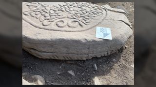 This image shows a close-up of an ogham alphabet inscription on a Pictish cross slab.