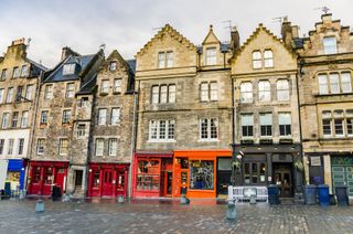 Historic Terraced Houses and Colourful Shopfronts in Gassmarket Square, Edinburgh Old Town