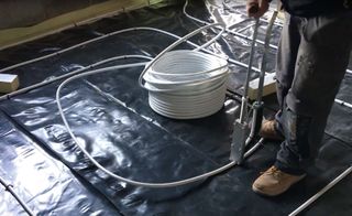 Putting the wet underfloor heating pipes in place