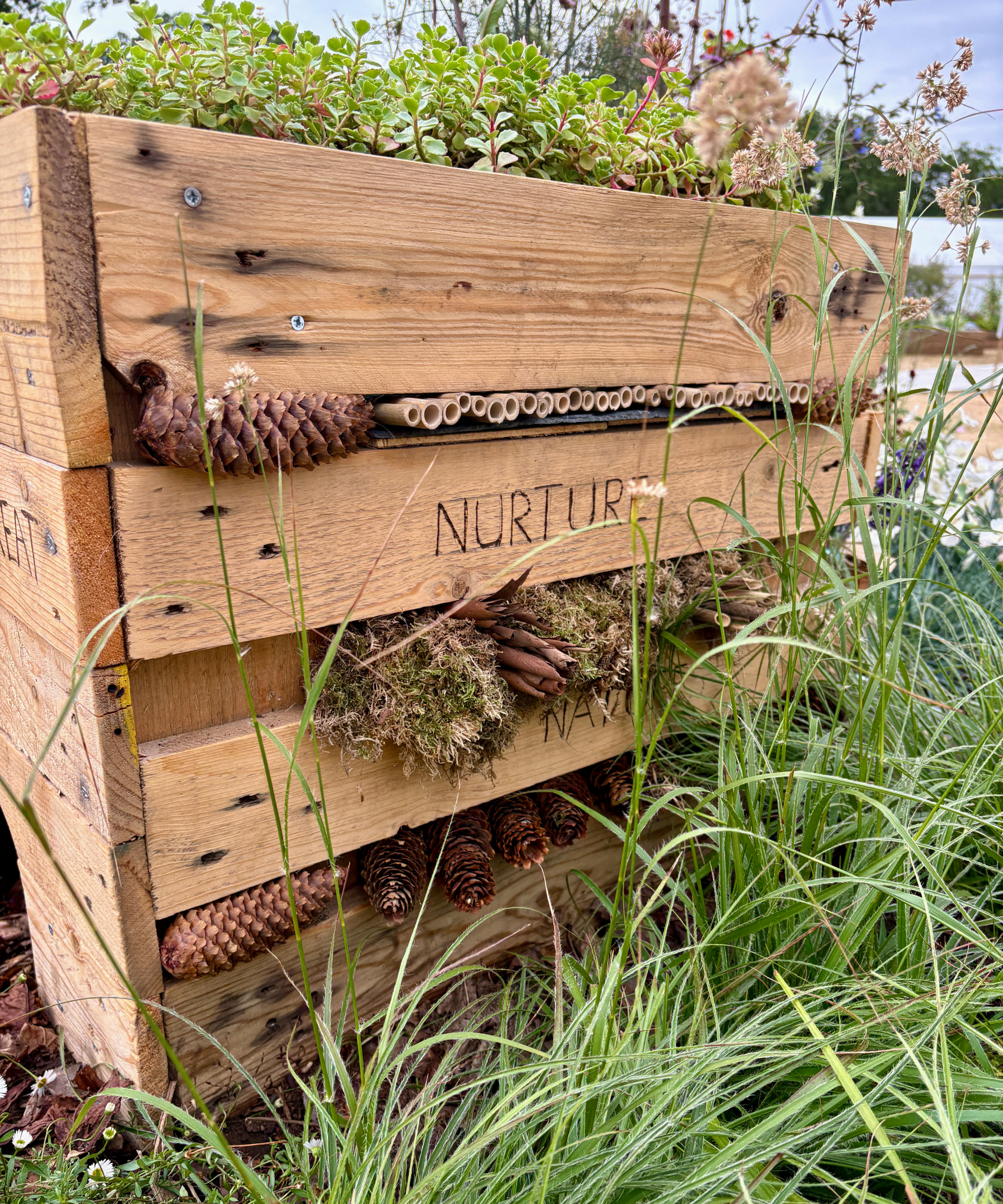 DIY bug hotel build of wood offcuts in a wildlife garden