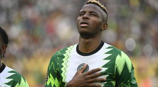 Victor Osimhen of Nigeria sings the Nigerian national anthem prior to the FIFA World Cup 2022 qualifying match between Nigeria and Ghana at the Moshood Abiola National Stadium on March 29, 2022 in Abuja, Nigeria.