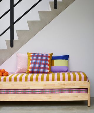 entryway with bench with colorful cushions