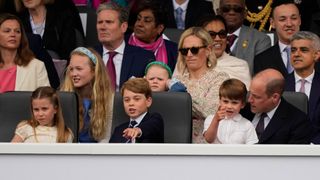 Princess Charlotte of Cambridge, Prince George of Cambridge, Prince Louis of Cambridge and Prince William, Duke of Cambridge watch the Platinum Pageant