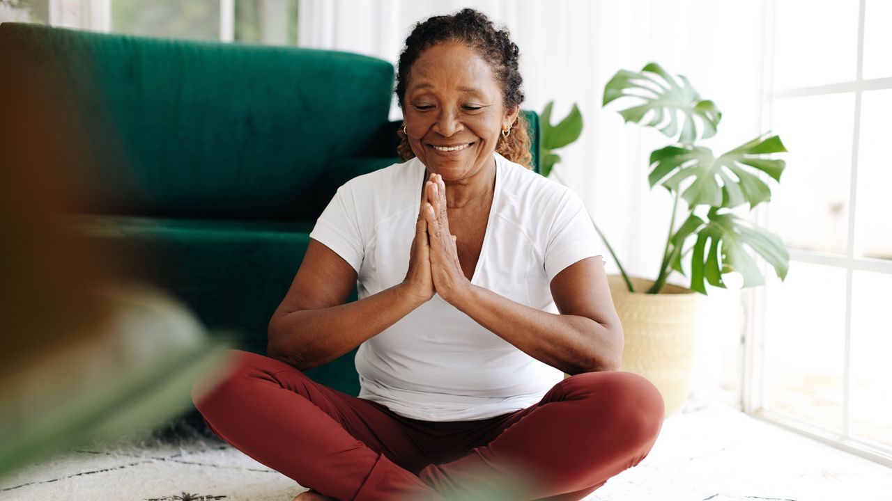 Woman doing morning yoga practice at home