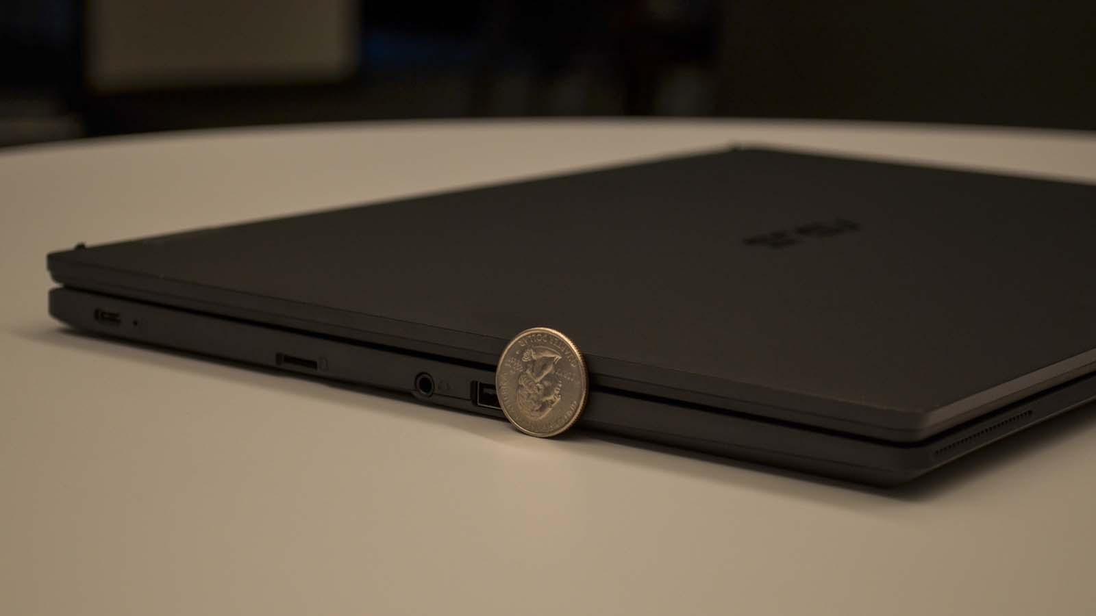 A US quarter next to the Asus Chromebook CX1500 to show its relative size