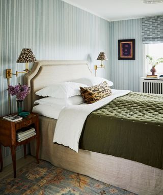 striped wallpaper in a bedroom with linen bed and bed skirt