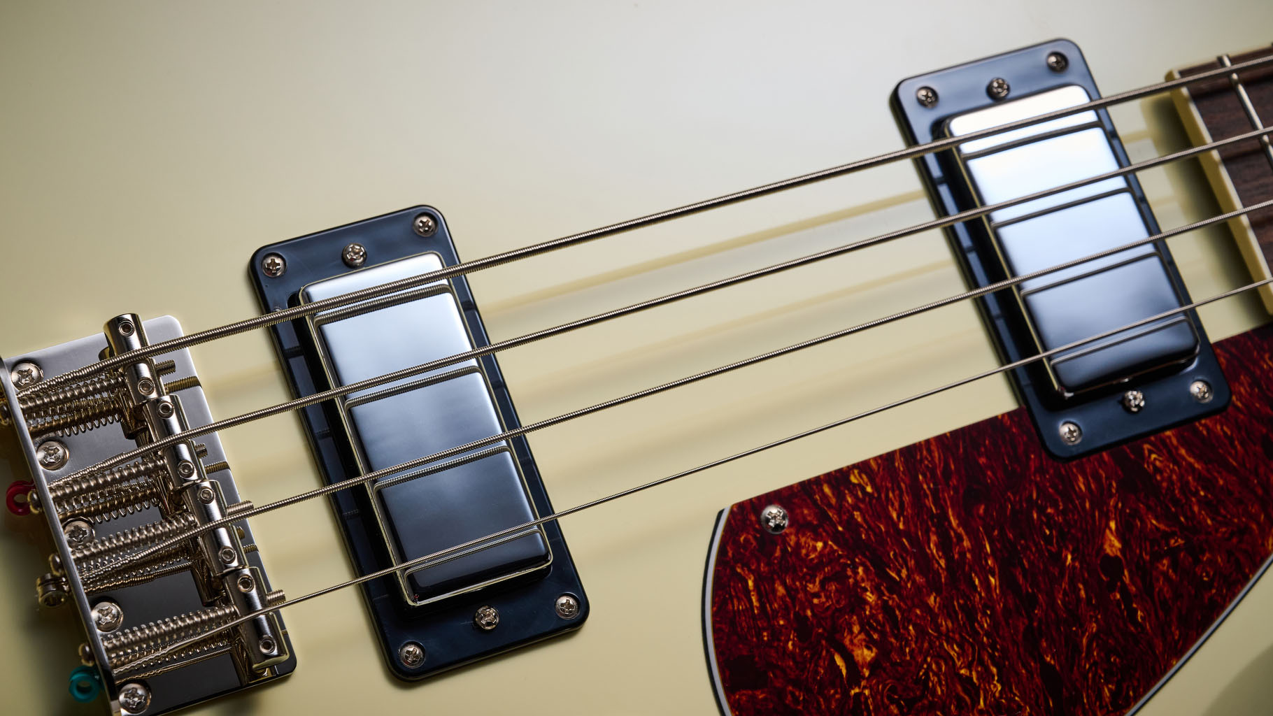 Gretsch Electromatic CVT Bass Double-cut: the retro-styled cream-colored four-string is pictured in close-up against a shaggy brown carpet.