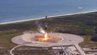 A SpaceX Falcon 9 rocket first-stage booster approaches Landing Zone 1 at Cape Canaveral Air Force Station in Florida after launching a Dragon cargo delivery mission to the International Space Station for NASA on Dec. 15, 2017. It marked the second launch for Falcon 9 booster and Dragon spacecraft.