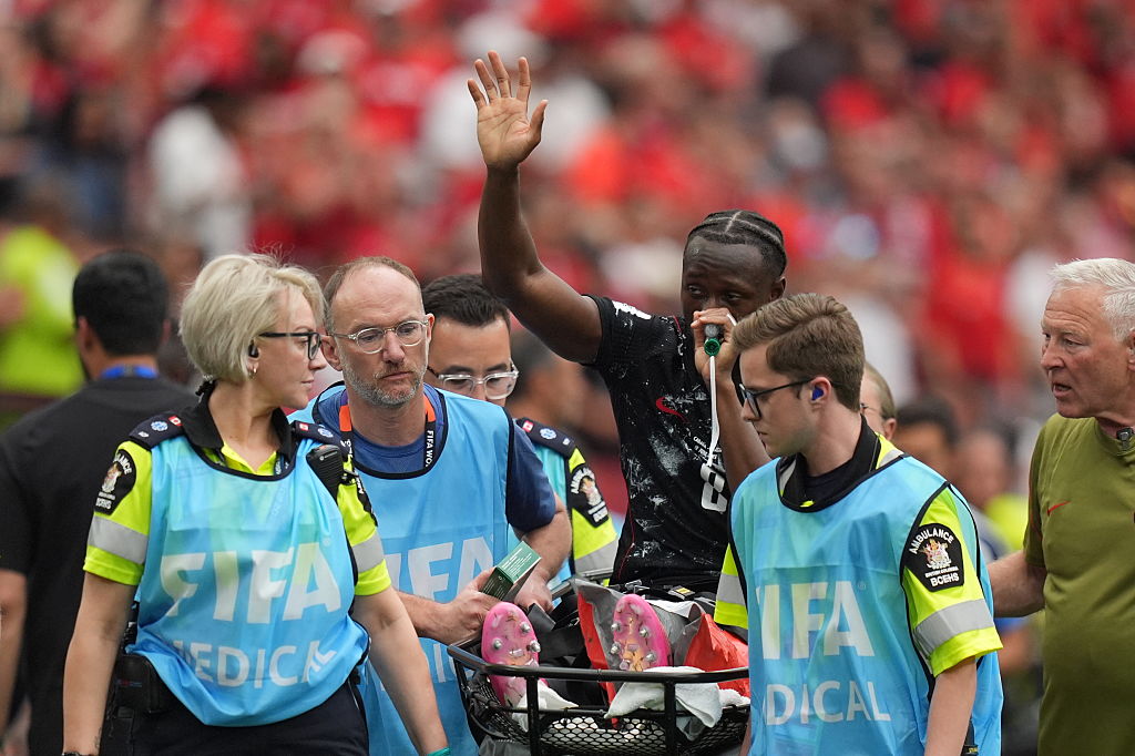 Ismael Kone of Canada leaves the pitch on a stretcher