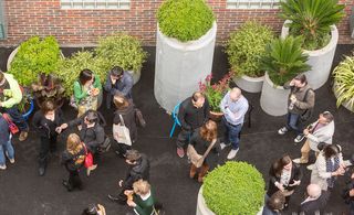 View from above of Gibbon's Rent alley filled with people and green plants in grey pots