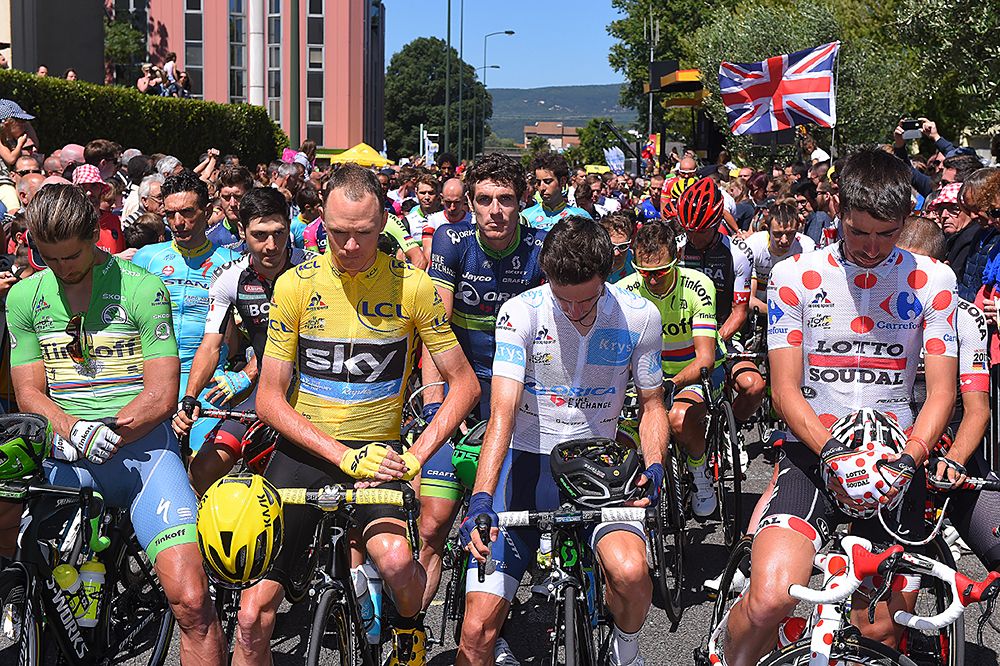 Riders take a moment of silence in honour of the attacks in Nice, at the start of stage 14 Tour de France