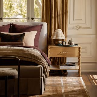 A wooden bedside table with wavy legs