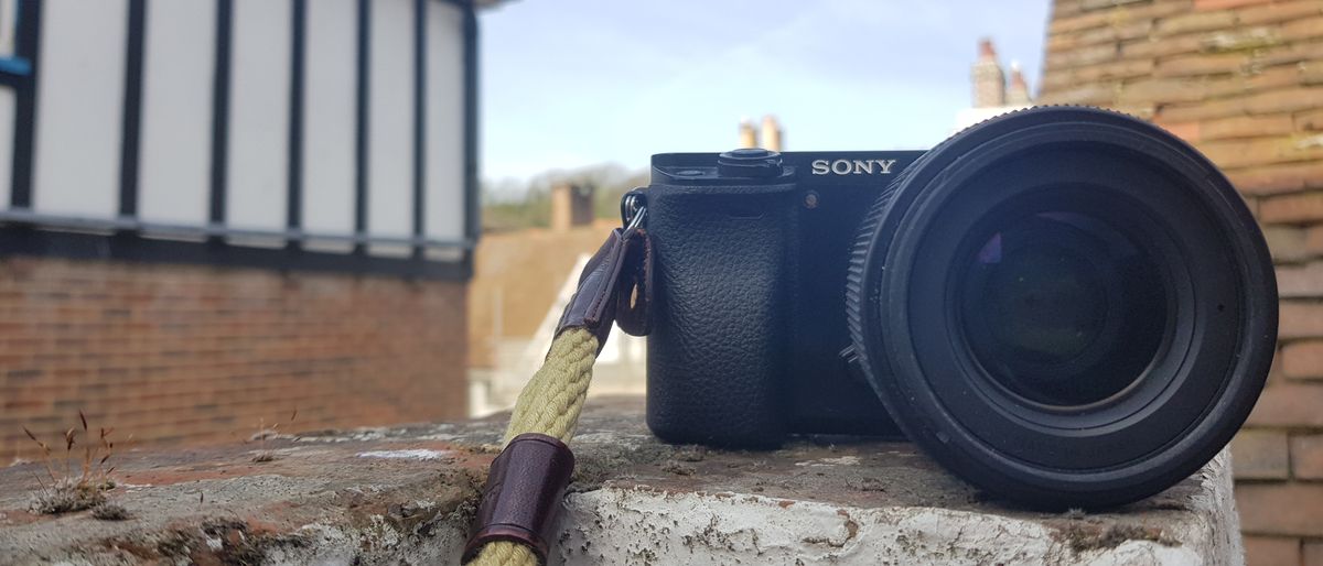 Photograph of Sony A6000 camera on stone wall: Sony A6000 review