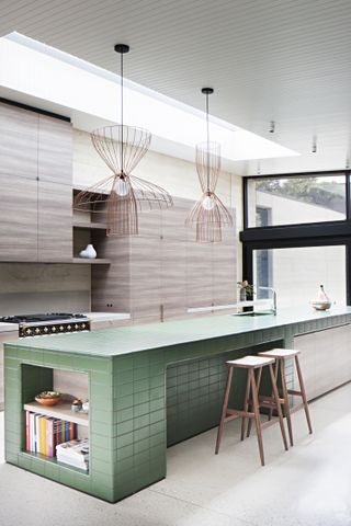 Green tiled kitchen island by Robson Rak Architects