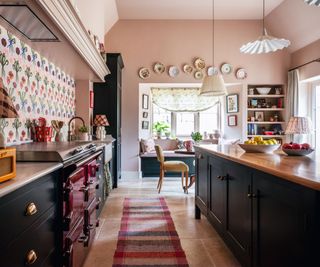 kitchen with pink walls and patterned tiled splashback