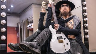 Dave Navarro poses with his Jet White PRS Dave Navarro Signature Custom 24 backstage at L’Olympia in Paris, prior to Jane’s Addiction’s show, June 26, 2024.