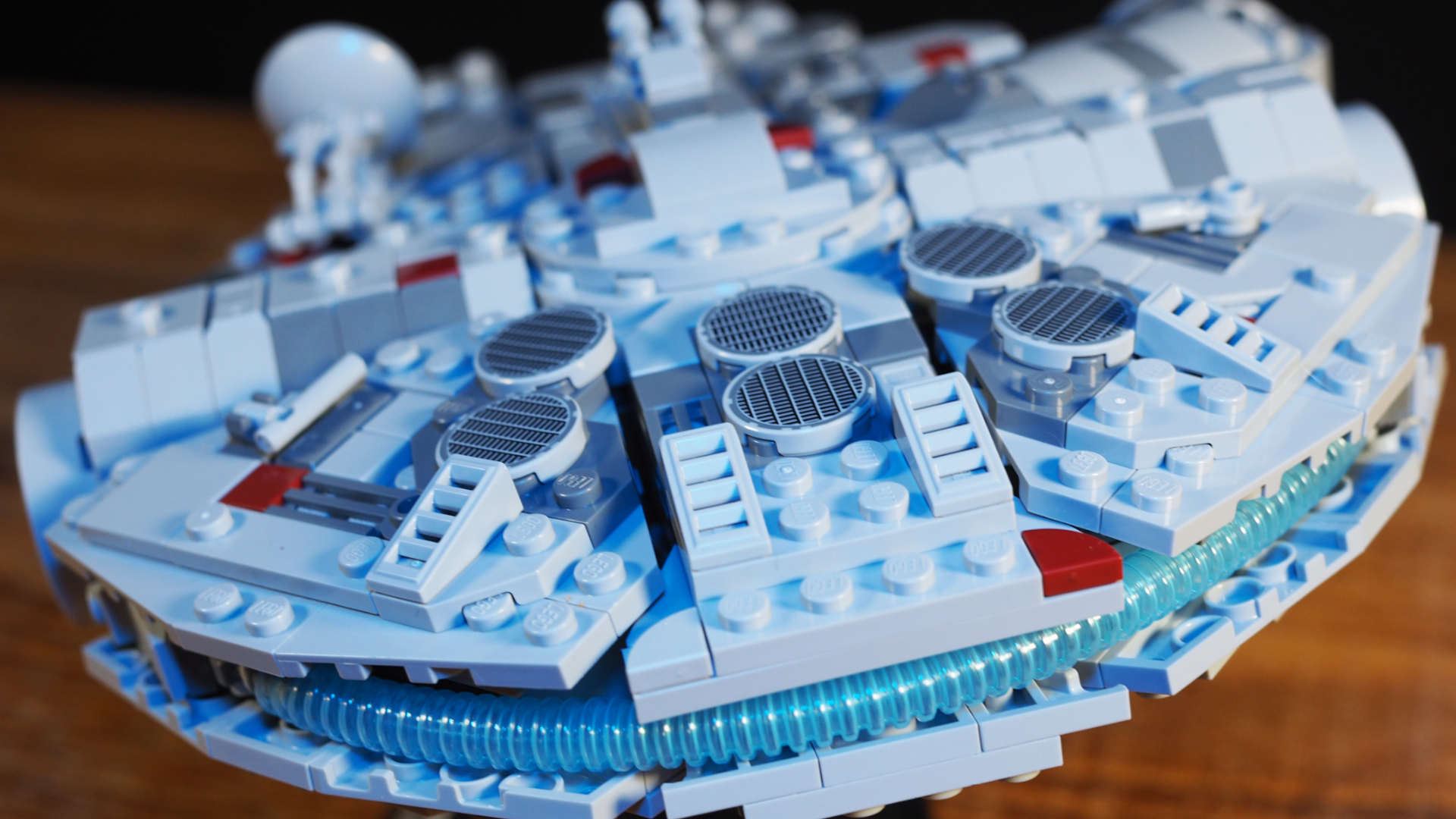 Lego Millennium Falcon set laid out on a wooden surface