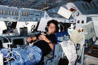 Floating freely on the flight deck, Sally Ride communicates with ground controllers in Houston during her STS-7 mission in June 1983.