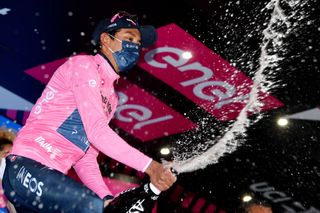 CORTINA DAMPEZZO ITALY MAY 24 2of Colombia and Team INEOS Grenadiers Pink Leader Jersey celebrates at podium during the 104th Giro dItalia 2021 Stage 16 a 153km stage shortened due to bad weather conditions from Sacile to Cortina dAmpezzo 1210m Champagne girodiitalia Giro on May 24 2021 in Cortina dAmpezzo Italy Photo by Stuart FranklinGetty Images