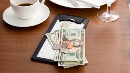 A tip sitting on top of the check 