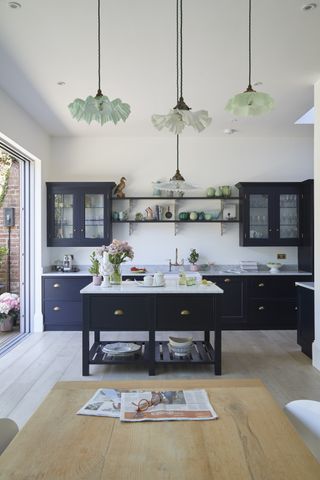 A kitchen with lots of pendant lighting.