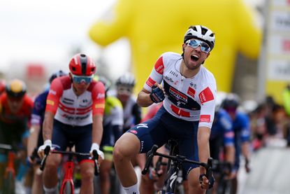 Ethan Vernon celebrates winning stage one of the Tour de Romandie 2023