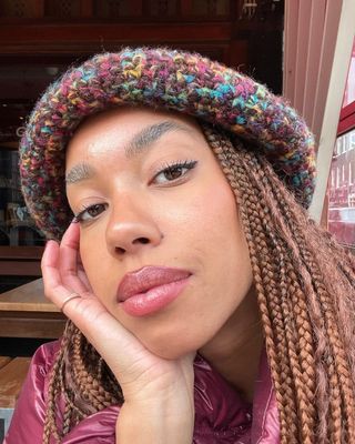 Amaka Hamelijnck with long lashes and a berry-toned lip