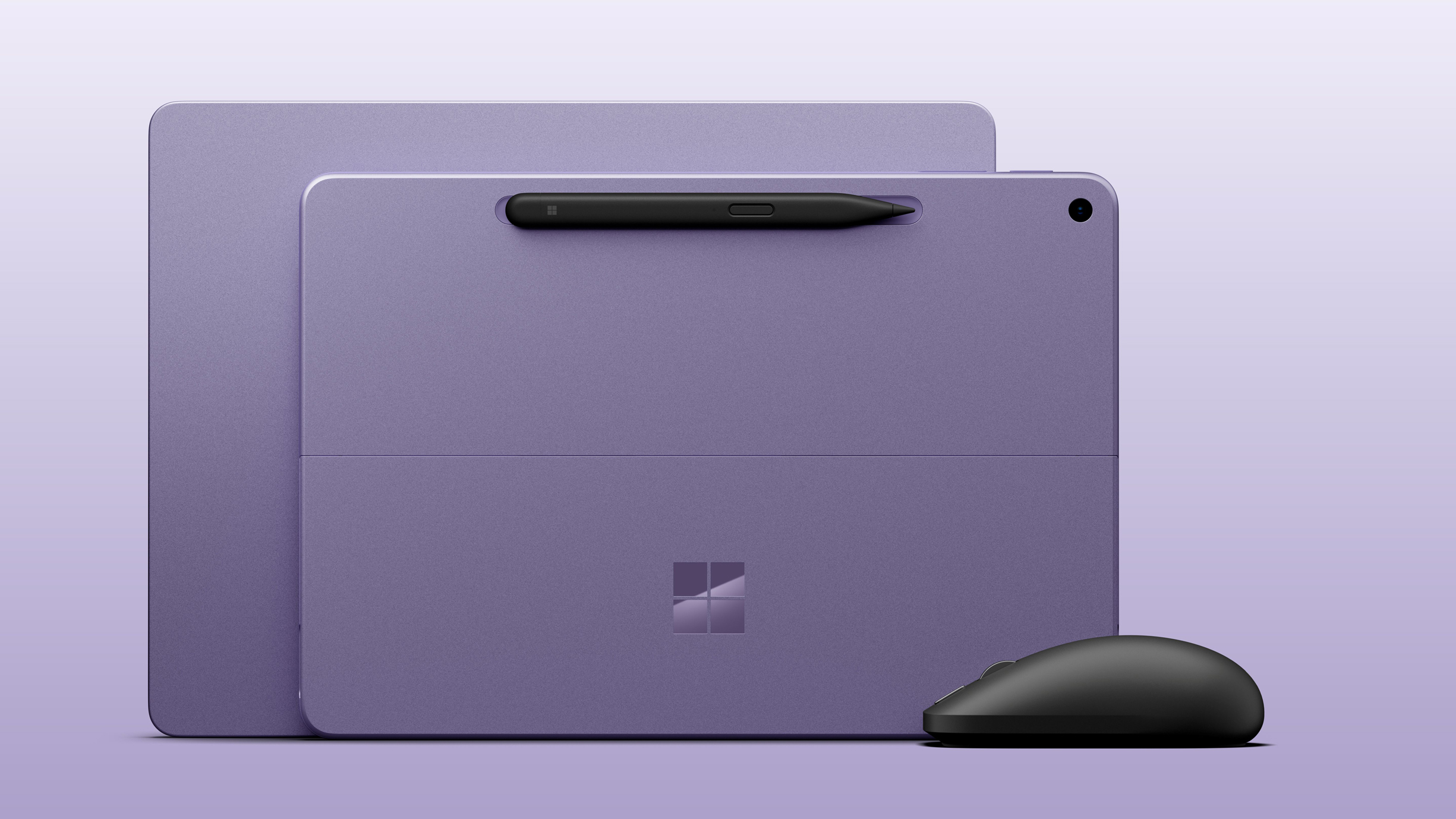 Microsoft Surface Laptop 13-inch next to Surface Laptop 12-inch, both in violet colorway next to the new black Surface Mouse.