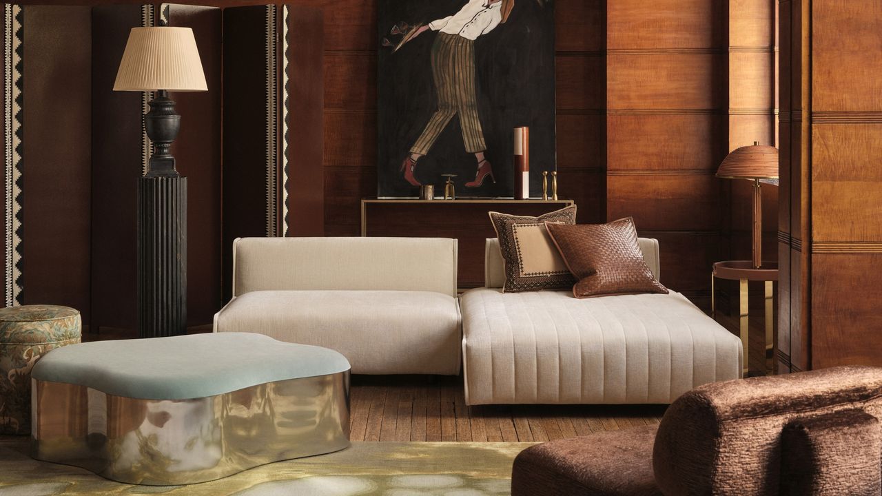 a leather sofa in a room with wood walls and a lamp on a plinth