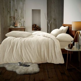 A bedroom with teddy bear fleece bedding